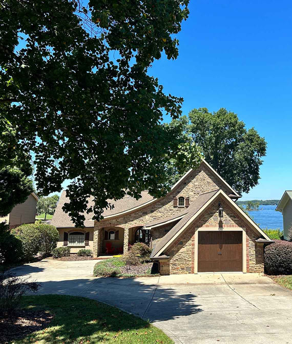 front of home with lake in background